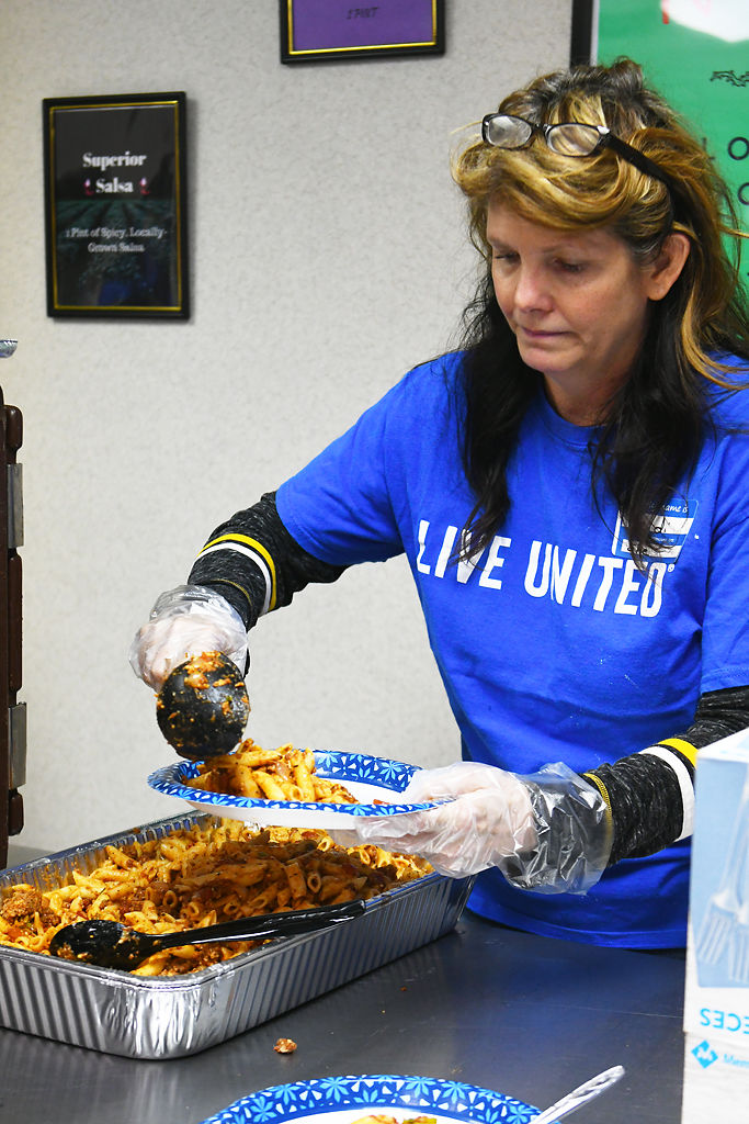 Heidi Twenter serves pasta during the Project Homeless Connect winter 2020